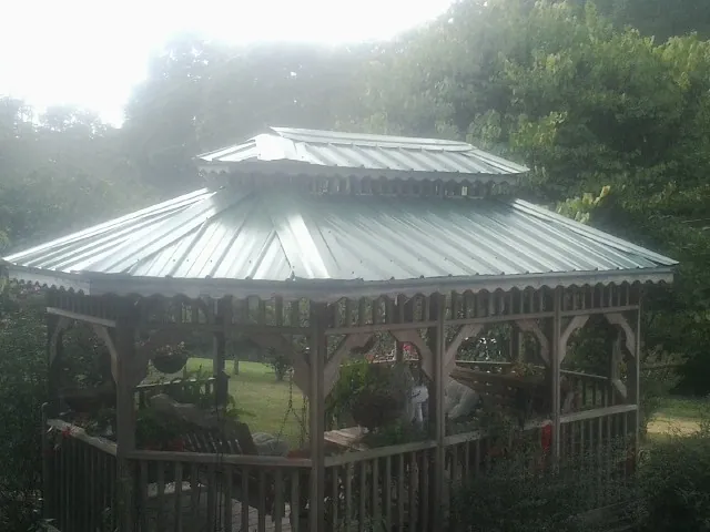 Two tier green metal roof on a garden gazebo in Glyndon
